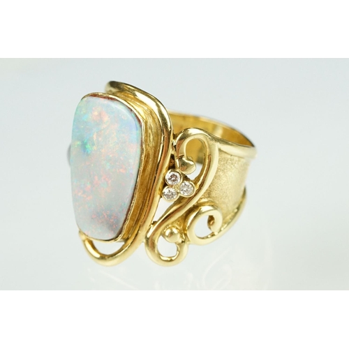 9 - Opal, moonstone and diamond 18ct yellow gold ring, the precious white opal displaying indigo, blue, ... 