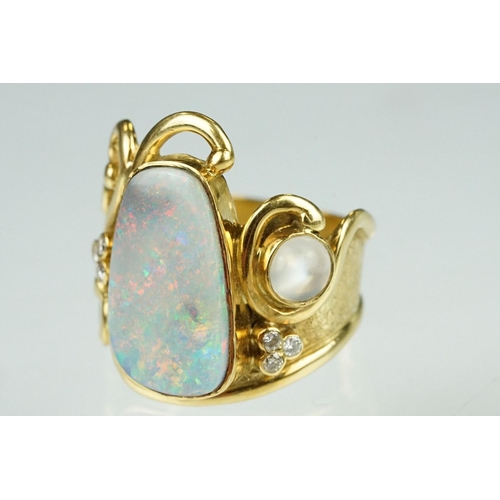 9 - Opal, moonstone and diamond 18ct yellow gold ring, the precious white opal displaying indigo, blue, ... 