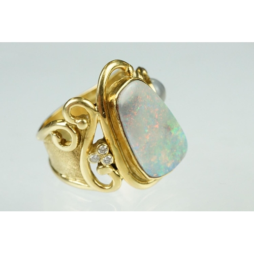 9 - Opal, moonstone and diamond 18ct yellow gold ring, the precious white opal displaying indigo, blue, ... 