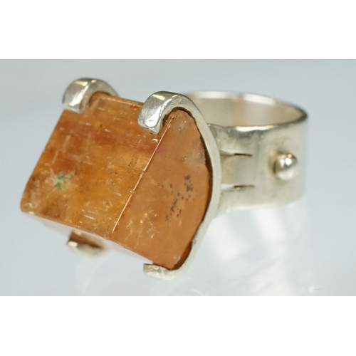 95 - Gem set silver ring, the faceted asymmetric orange stone probably orange topaz, dimensions approx 17... 