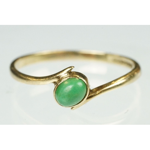 97 - Turquoise 9ct yellow gold crossover ring, the oval cabochon cut turquoise measuring approx 5mm x 3.5... 