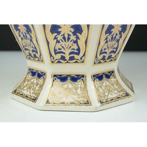 15 - Set of four 20th Century ceramic vases of panelled octagonal design, each each having blue and gilt ... 