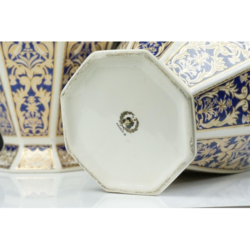 15 - Set of four 20th Century ceramic vases of panelled octagonal design, each each having blue and gilt ... 