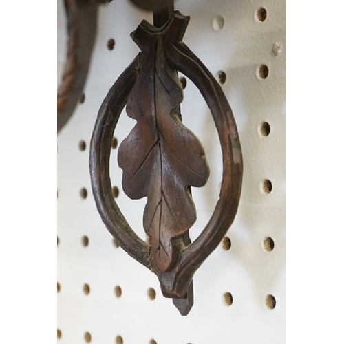 16 - 19th Century carved black forest pendulum wall clock having a round clock to the centre with enamell... 