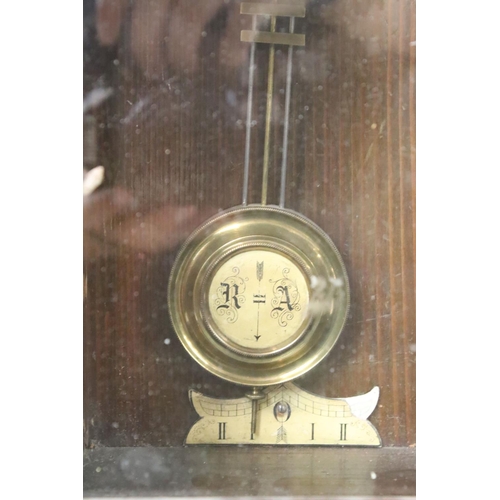 188 - An antique wooden cased wall clock with brass and enamel dial, Roman numeral markers, complete with ... 