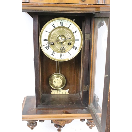 188 - An antique wooden cased wall clock with brass and enamel dial, Roman numeral markers, complete with ... 