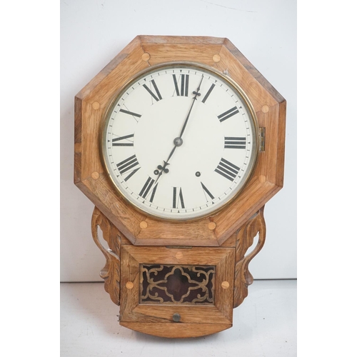 189 - A vintage wooden cased wall clock, white enamel dial with Roman numeral markers.