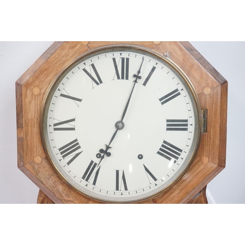 189 - A vintage wooden cased wall clock, white enamel dial with Roman numeral markers.
