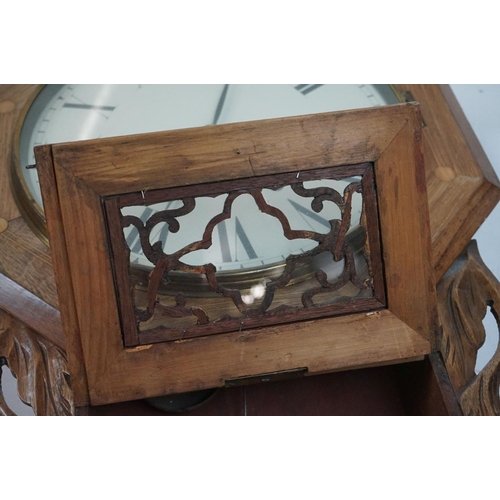 189 - A vintage wooden cased wall clock, white enamel dial with Roman numeral markers.