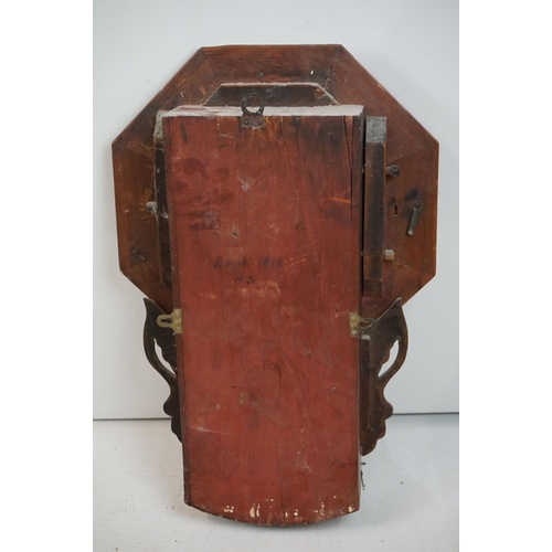 189 - A vintage wooden cased wall clock, white enamel dial with Roman numeral markers.