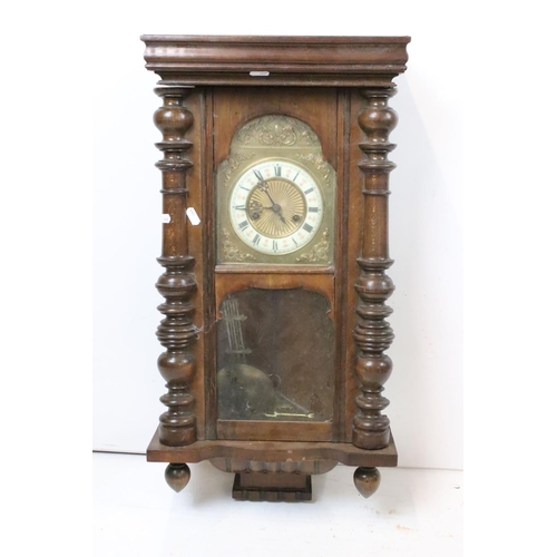 190 - An antique wooden cased wall clock with brass and enamel dial, Roman numeral markers, complete with ... 