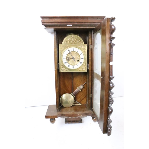 190 - An antique wooden cased wall clock with brass and enamel dial, Roman numeral markers, complete with ... 