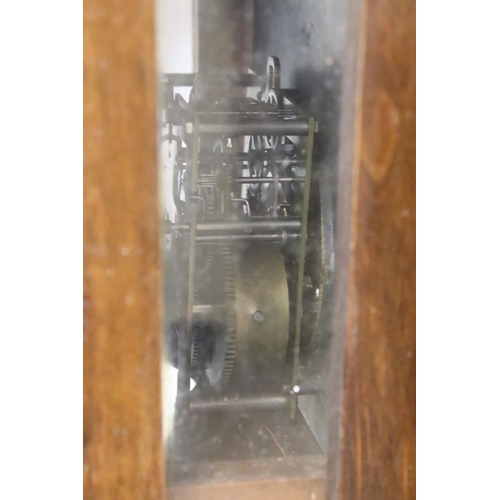 190 - An antique wooden cased wall clock with brass and enamel dial, Roman numeral markers, complete with ... 