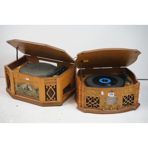 194 - Two vintage style music centres to include record player, CD player, radio and Aux line.