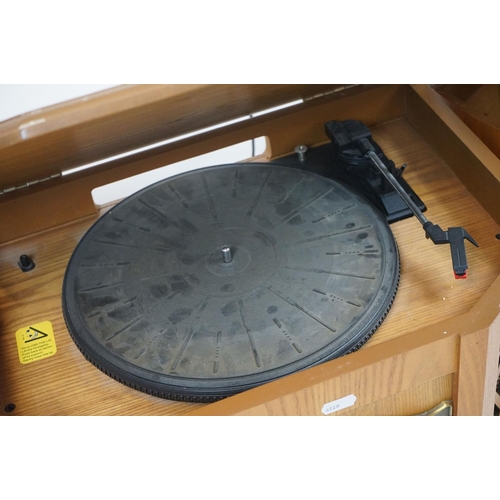 194 - Two vintage style music centres to include record player, CD player, radio and Aux line.