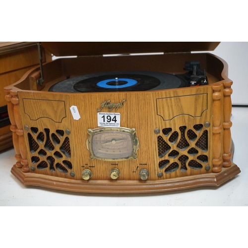 194 - Two vintage style music centres to include record player, CD player, radio and Aux line.