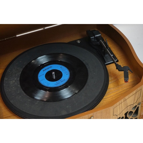 194 - Two vintage style music centres to include record player, CD player, radio and Aux line.