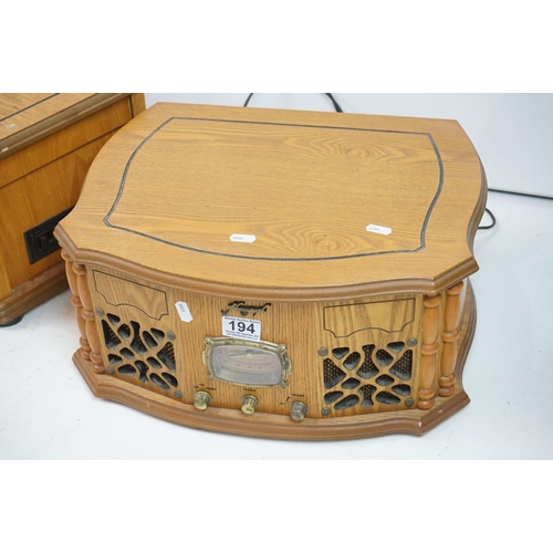 194 - Two vintage style music centres to include record player, CD player, radio and Aux line.