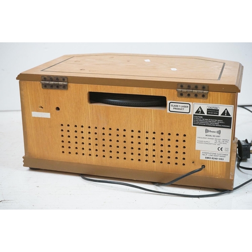 194 - Two vintage style music centres to include record player, CD player, radio and Aux line.