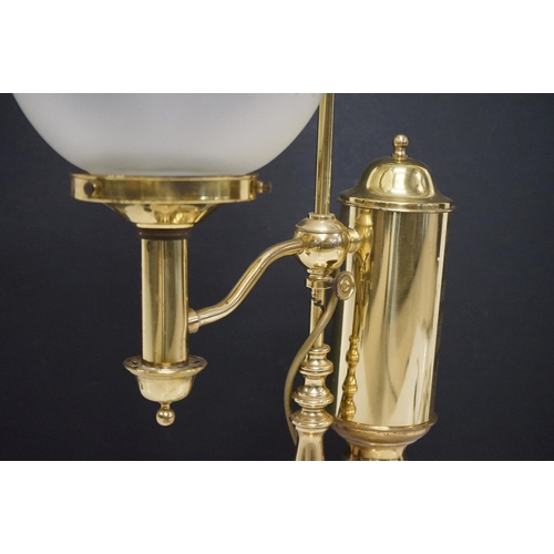 202 - Brass table lamp, the globular shade of etched design, 57.5cm high