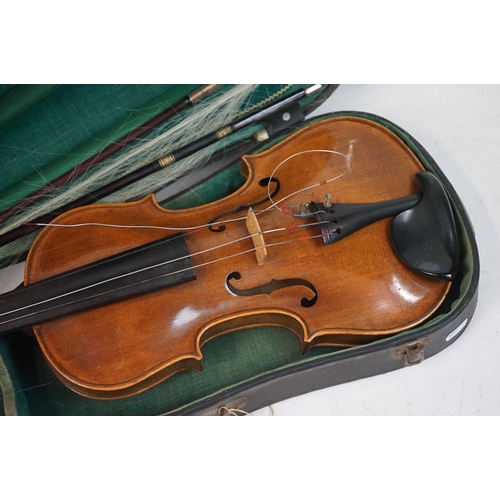203B - A violin together with two violin bows, cased, label suggests this was possibly the property of Fran... 