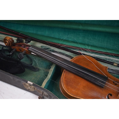 203B - A violin together with two violin bows, cased, label suggests this was possibly the property of Fran... 