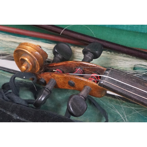 203B - A violin together with two violin bows, cased, label suggests this was possibly the property of Fran... 