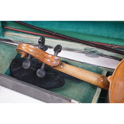 203B - A violin together with two violin bows, cased, label suggests this was possibly the property of Fran... 