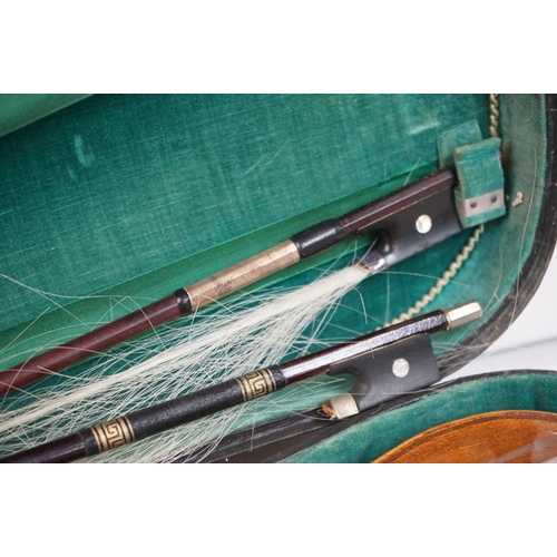 203B - A violin together with two violin bows, cased, label suggests this was possibly the property of Fran... 