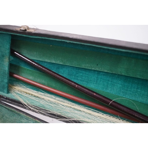 203B - A violin together with two violin bows, cased, label suggests this was possibly the property of Fran... 