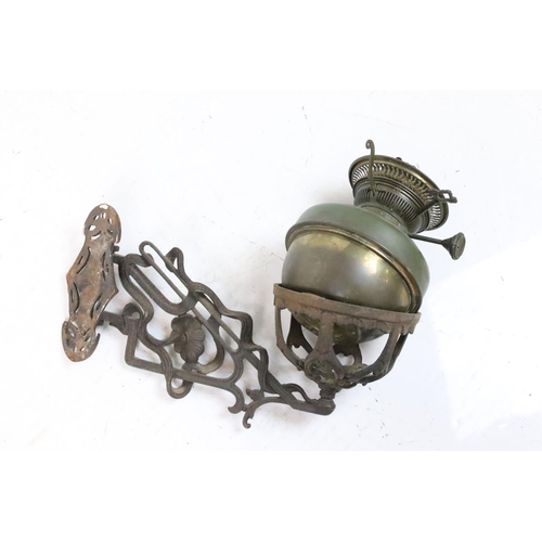 205 - Wrought iron basket on a hinged bracket, decorated with a scrolling design and a flower, impressed '... 
