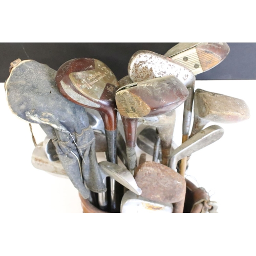 216 - Collection of golf clubs, within a canvas and leather bag, to include many Bobby Locke Triple Crown ... 