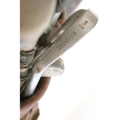 216 - Collection of golf clubs, within a canvas and leather bag, to include many Bobby Locke Triple Crown ... 