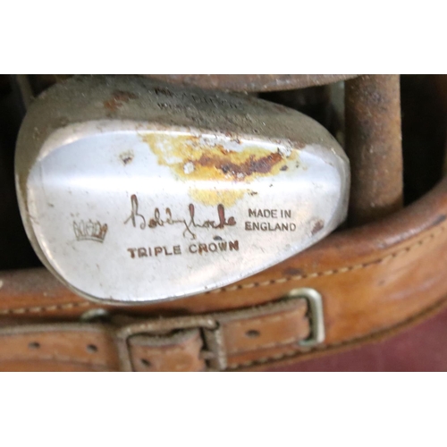 216 - Collection of golf clubs, within a canvas and leather bag, to include many Bobby Locke Triple Crown ... 