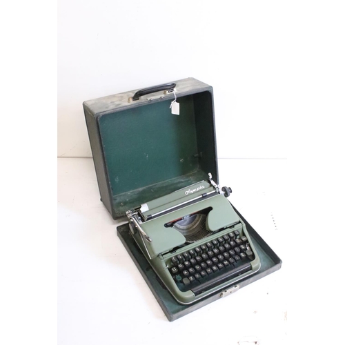 218 - Three typewriters, comprising: a Burroughs, an Olympia, cased and a Remington Rand, cased