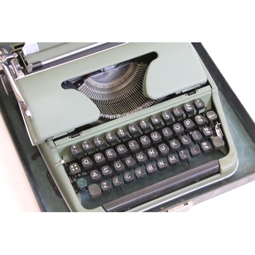 218 - Three typewriters, comprising: a Burroughs, an Olympia, cased and a Remington Rand, cased