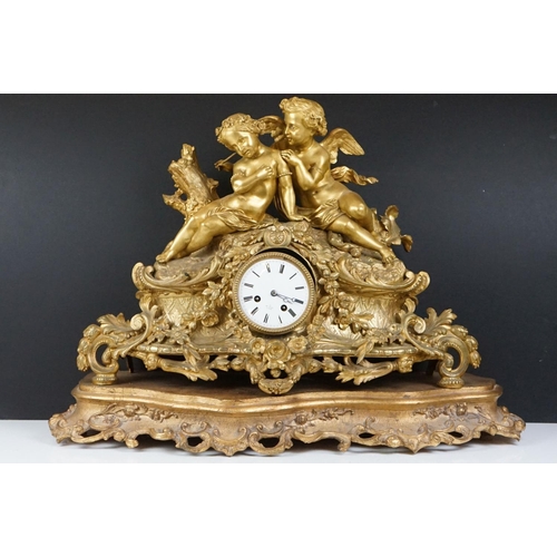 26 - 19th Century gilt metal mantle clock having a central white enamelled face with roman numerals to th... 