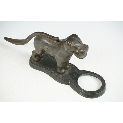 31 - Pair of early 20th Century cast iron nut crackers in the from of dogs with mechanical tails and jaws... 