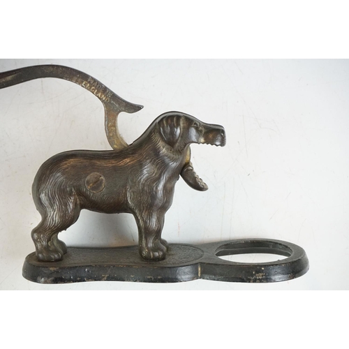 31 - Pair of early 20th Century cast iron nut crackers in the from of dogs with mechanical tails and jaws... 