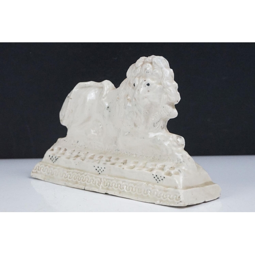 43 - Early 20th Century ceramic lion flat back figurine, depicted crouched on a moulded base. Signed Lily... 