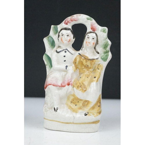 44 - 19th Century Victorian Staffordshire ceramic figurines to include a flat back couple, cat, veiled wo... 