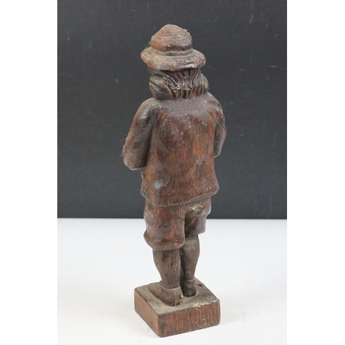 9 - Carved oak black forest style figure depicting a piper, together with a 1930's carved wooden novelty... 