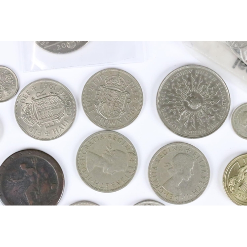 599 - A small collection of British coins and banknotes to include two white £5 notes and a small quantity... 