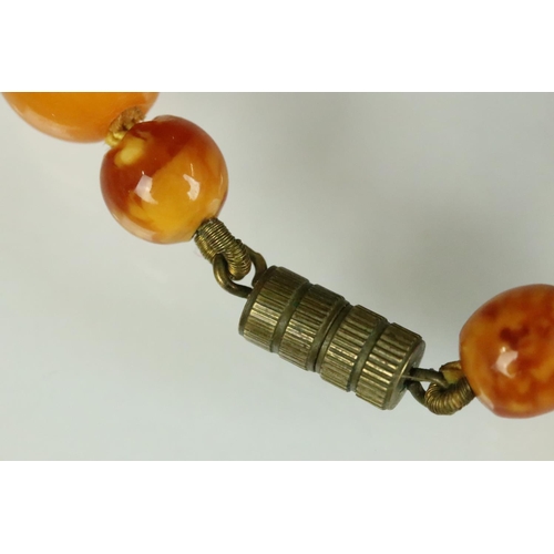 19 - Early 20th century Butterscotch amber bead necklace, thirty-three graduated oval and circular beads,... 