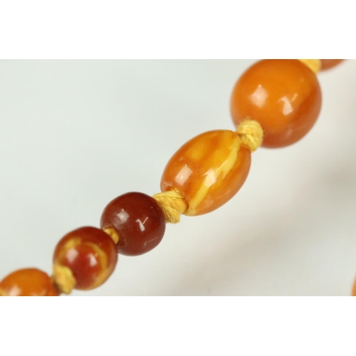 22 - Early 20th century Butterscotch amber bead necklace, forty-two oval and round graduated beads, the l... 