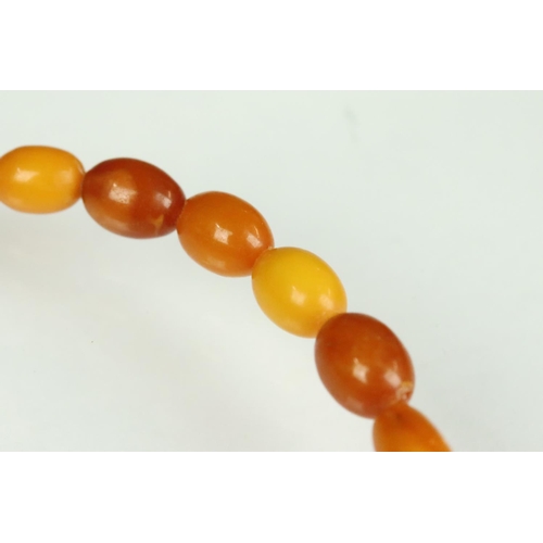 23 - Butterscotch amber necklace, thirty-nine graduated oval beads, the smallest bead measuring approx 6m... 