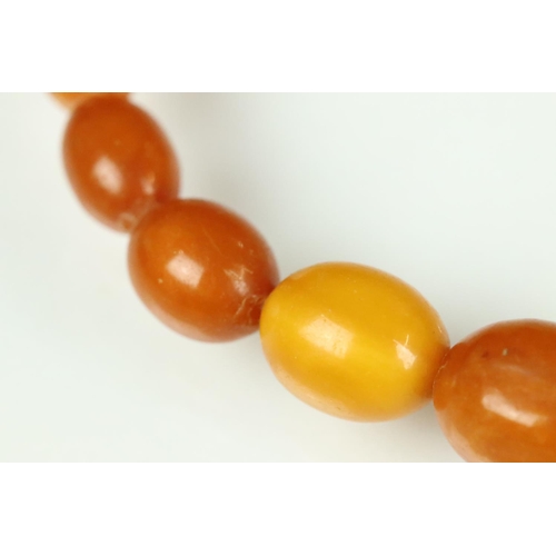 23 - Butterscotch amber necklace, thirty-nine graduated oval beads, the smallest bead measuring approx 6m... 