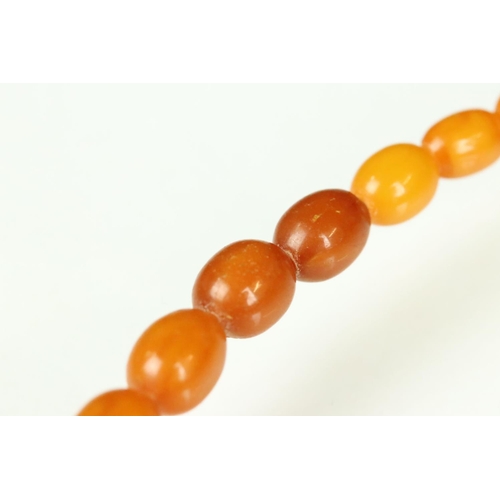 23 - Butterscotch amber necklace, thirty-nine graduated oval beads, the smallest bead measuring approx 6m... 