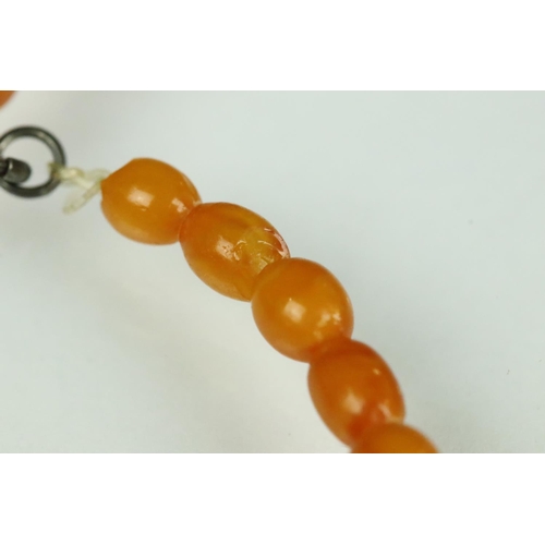 23 - Butterscotch amber necklace, thirty-nine graduated oval beads, the smallest bead measuring approx 6m... 