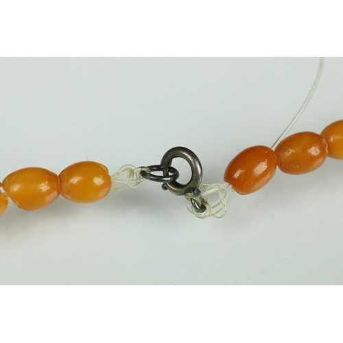 23 - Butterscotch amber necklace, thirty-nine graduated oval beads, the smallest bead measuring approx 6m... 